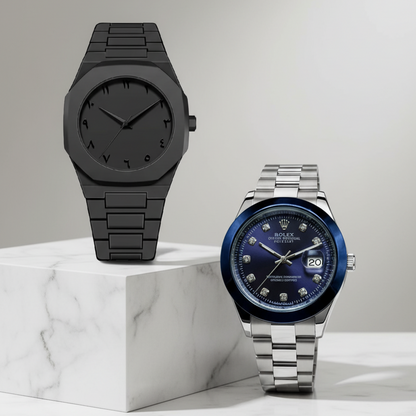 Two watches, one black and one with a blue face, on a marble surface.
